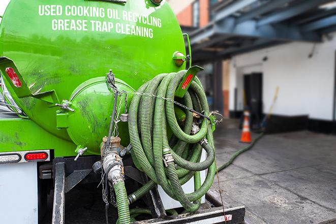 a vacuum truck pumping out a large underground grease trap in Catlin IL